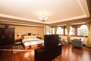 a large bedroom with a bed and a chandelier at Denzong Regency- Luxury Mountain Retreat Spa & Casino in Gangtok