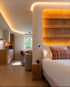 a bedroom with a bed and a living room at La Venta de Bodegas Ostatu in Samaniego