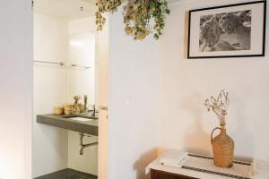 a bathroom with a sink and a mirror at Casa Pereirinha \ Pateo House in Vidigueira