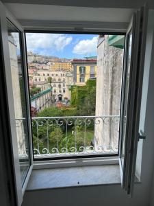 a window with a view of a city at Dal Console - Piazza Bellini - Napoli in Naples