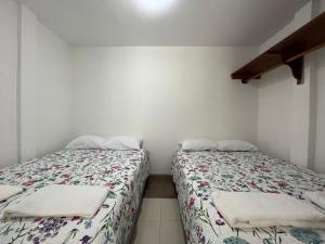 two beds sitting next to each other in a room at Brand new Holiday Villa - 3 bedroom 4 bathroom in Baños