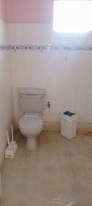 a bathroom with a white toilet in a room at Mara bush house in Sekenani
