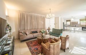 a living room with a couch and a table at Ella Sun Villa Geffen in Eilat