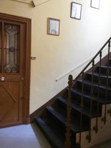 a room with a staircase with a wooden door at Studio 11T Sleeps 2 with WiFi in Beausoleil
