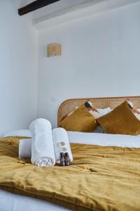 two beds in a room with towels and syrup at Apartment Le Marais by Studio prestige in Paris