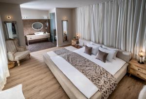 a large bedroom with a large bed and a bathroom at Ella Sun Villa Geffen in Eilat +43 photos