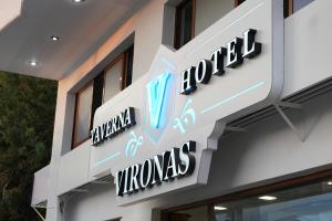 a sign on the side of a building at Vironas Hotel in Himare