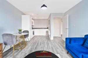 Una sala de estar con un sofá azul y una mesa. en 1 Bedroom Apartments in Digbeth, en Birmingham