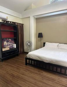 a bedroom with a bed and a fireplace at Pattaya 6 bedroom pool villa in Jomtien Beach