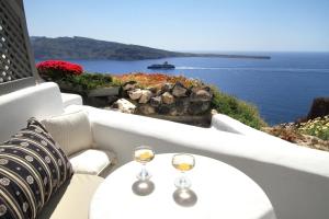 a view from the balcony of a restaurant overlooking a body of water at Finesse Suites in Oia
