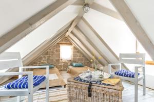 a room with a table and chairs in a attic at Holiday Home Vintage in Split