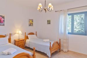 a bedroom with two beds and a window at Es Lliri Blanc in Cala Saona