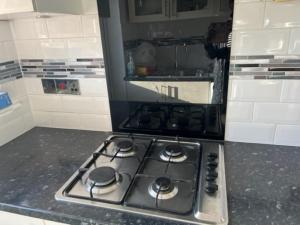 a kitchen with a stove top oven in a kitchen at 3 bedroom mid terraced house (2 double & 1 single) in Grays Thurrock