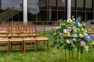 an aisle with chairs and a bunch of flowers at Hilton Alexandria Mark Center in Alexandria