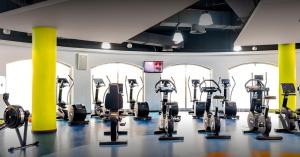 a gym with several treadmills and cardio machines at Dubai Eye in Dubai