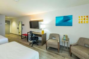 a hotel room with a bed and a desk and a tv at Comfort Inn Mont Laurier in Mont-Laurier