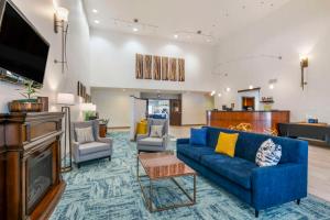 a living room with a couch and a tv at Comfort Suites Conference Center Rapid City in Rapid City