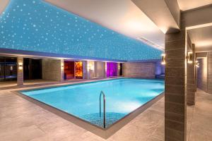 a pool in a hotel with a ceiling with stars at DoubleTree by Hilton Harrogate Majestic Hotel & Spa in Harrogate