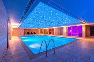 a swimming pool in a house with lights on it at DoubleTree by Hilton Harrogate Majestic Hotel & Spa in Harrogate