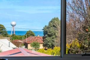 a window view of the ocean from a house at Silver Ball Retreat in Warrnambool