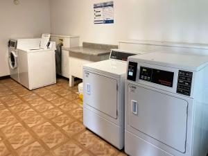 a laundry room with two washers and a dryer at Motel 6 Opelika AL in Opelika