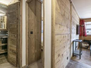 a room with a wooden wall with a door at Appartement ski aux pieds, centre Val d'Isère, jusqu'à 6 pers, WIFI - FR-1-519-31 in Val dʼIsère