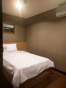 a bedroom with a large white bed in it at Two Bedroom Apartment at el Royale Hotel in Bandung