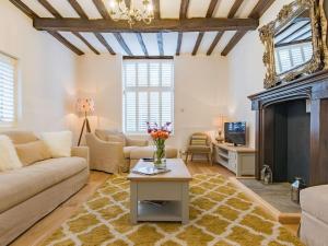 a living room with a couch and a fireplace at Townhouse with cathedral views in Kent