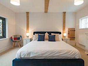 a bedroom with a large bed with blue accents at Townhouse with cathedral views in Kent