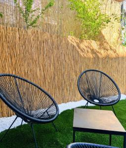 two metal chairs and a bench in a yard at Cozy Residence Sv. Duh in Zagreb