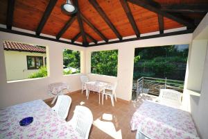 a room with two tables and chairs on a patio at Rooms Novaković in Opatija