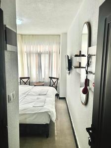 a bedroom with a white bed and a window at Noya Suites in Istanbul