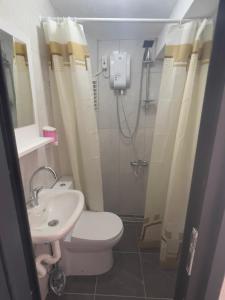 a bathroom with a shower and a toilet and a sink at Noya Suites in Istanbul