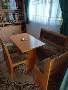 a dining room table with two chairs and a wooden table at Apartment 