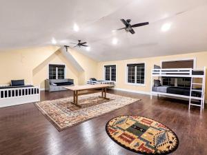 a living room with a table and a couch at The Athena Hideaway - hottub, firepit, lake & racetrack in Saratoga Springs