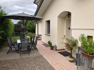a patio with a table and an umbrella at Bed and Breakfast La Sosta in Ponte San Nicolo