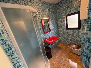 a bathroom with a red sink and a toilet at Bucharest Old Town Smardan Apartment in Bucharest