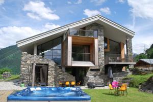a house with a pool in front of it at Mineral Lodge & Spa in Villaroger