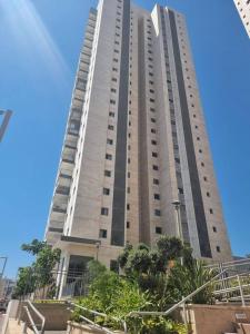 a large tall building with trees in front of it at דירת גג ים עכו חיפה נוף מרהיב in Acre