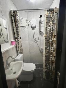 a small bathroom with a toilet and a sink at Noya Suites in Istanbul