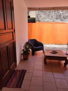 a room with a door and a chair and a table at les hauts de Remire Chambre studio indépendant calme avec piscine in Rémire-Camp