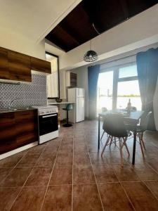 a kitchen with a table and a dining room at La Mansarda di Anastasia in Monteroni di Lecce