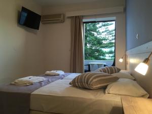 Postel nebo postele na pokoji v ubytování Apollon Hotel