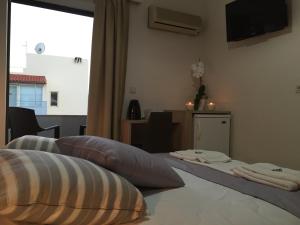 Postel nebo postele na pokoji v ubytování Apollon Hotel
