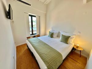 a bedroom with a large bed with a window at YOUROPO - Taipas in Porto
