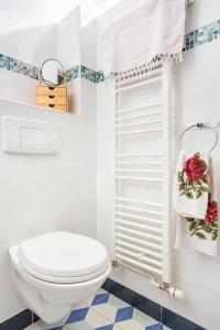 La salle de bains blanche est pourvue de toilettes et d'une fenêtre. dans l'établissement Cosy House Near Paris 4 Bedrooms, Metro, Parking, à Saint-Denis