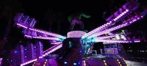 a roller coaster lit up at night with lights at Low Price Modern Apartment Aircon & Filter Water in San Pedro del Pinatar