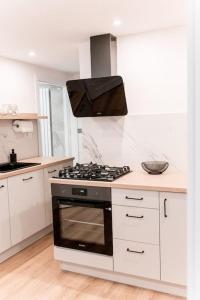 a kitchen with a stove top oven in a kitchen at Apartament Pastel Room in Leśna