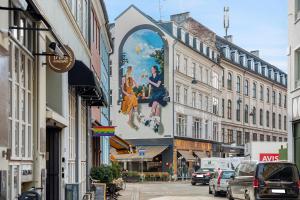 a building with a large painting on the side of a street at Sanders City - Spacious studio apartment in Copenhagen