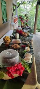 a long table with plates of food on it at Sítio Vale da Serra in Maranguape